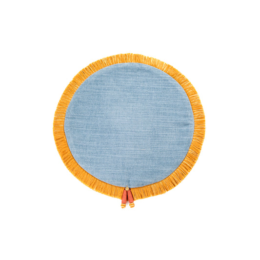 A round woven textile piece in light blue with a wide mustard-yellow fringe border and small hanging tassels, shown on a plain white background.